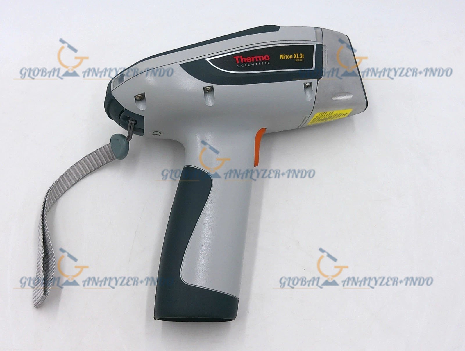 Technician using Niton XL3t-700 GOLDD handheld XRF analyzer on metal sample in industrial environment